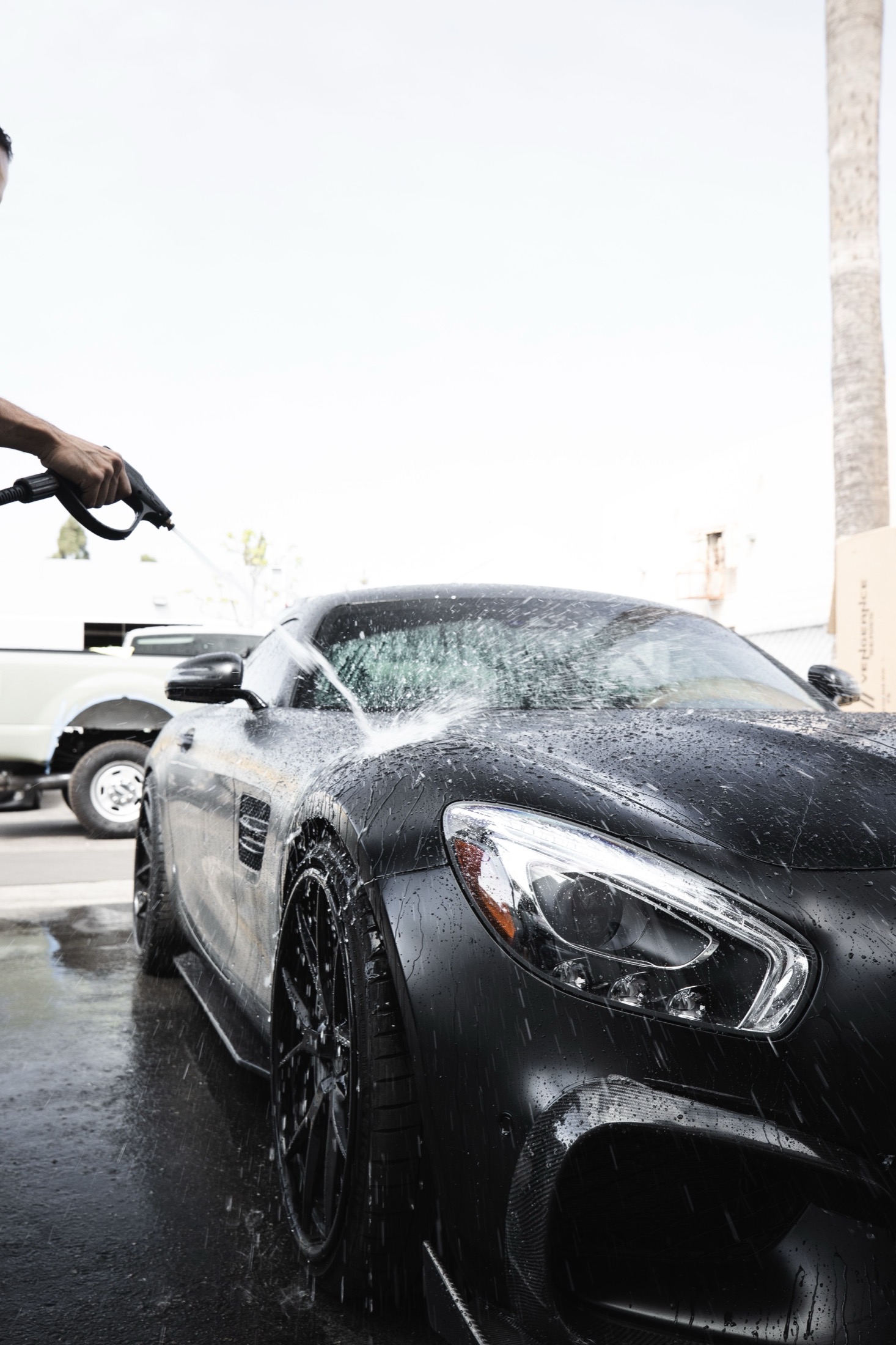 Exterior of a black vehicle being carefully cleaned